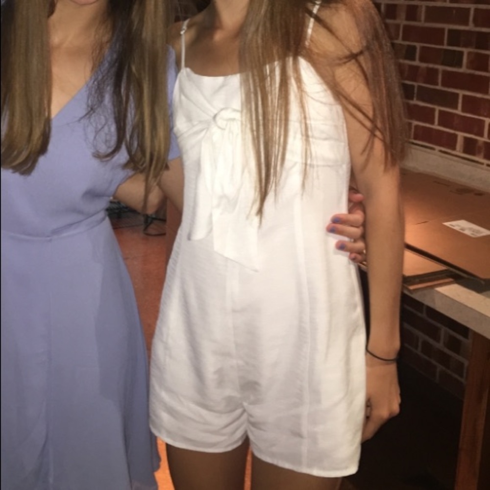 White tie front romper with adjustable straps and zip up back